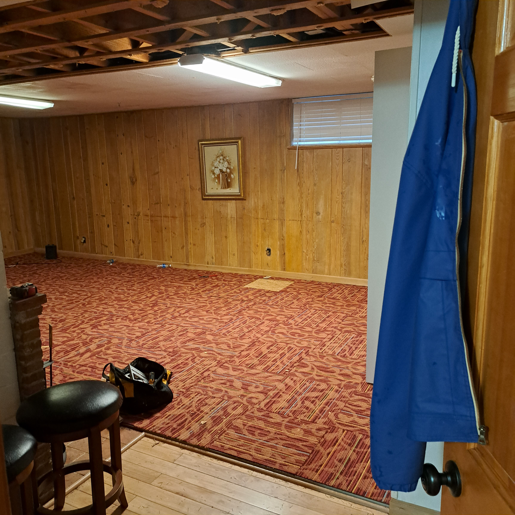 The room before the project. 0<br />laminate vinyl plank flooring installation in Seattle hold downstairs with the staircase