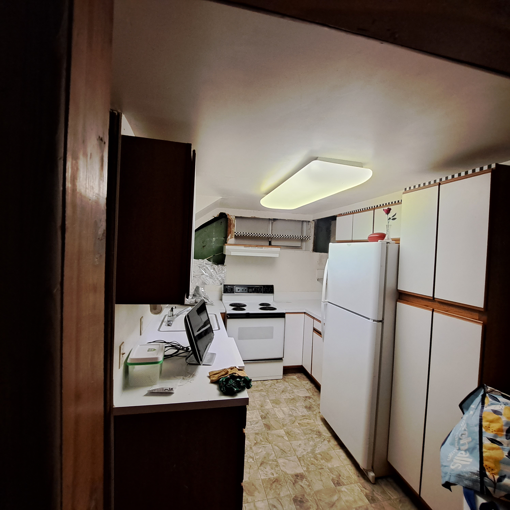 Kitchen area before the project. 0<br />laminate vinyl plank flooring installation in Seattle hold downstairs with the staircase