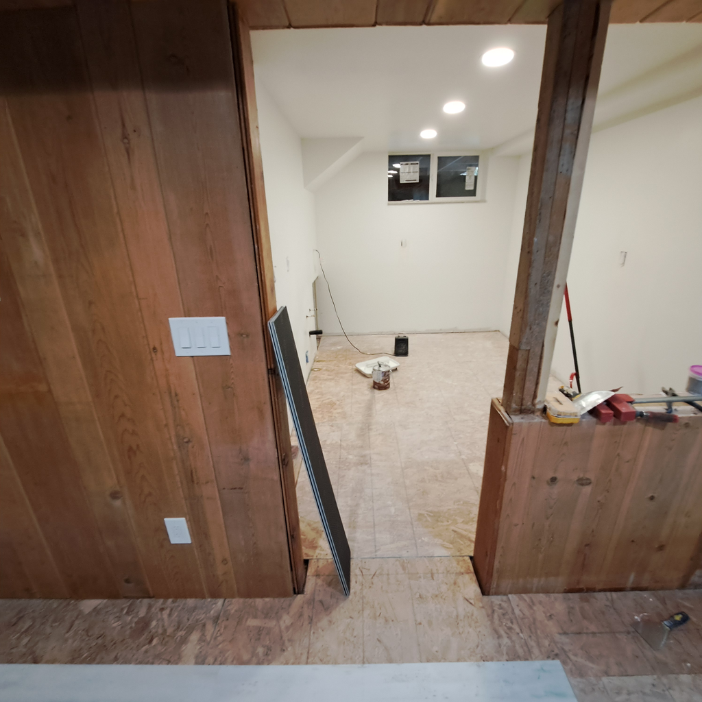 Side room during construction 0<br />laminate vinyl plank flooring installation in Seattle hold downstairs with the staircase