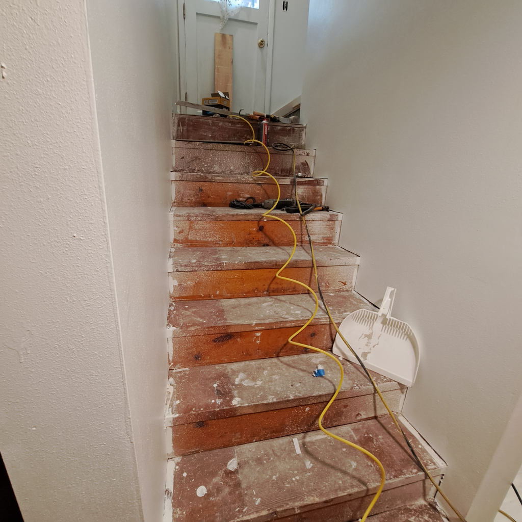Stairs leading to upstairs during renovation. 0<br />laminate vinyl plank flooring installation in Seattle hold downstairs with the staircase